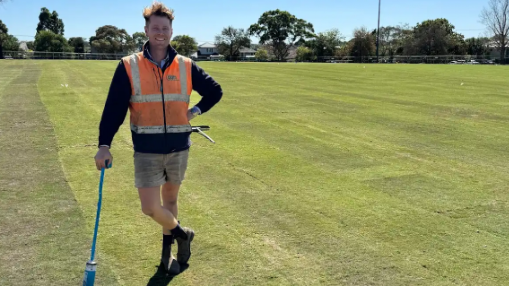 Grounds worker standing on a sports field