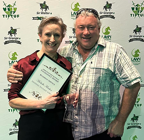 couple holding award certificate