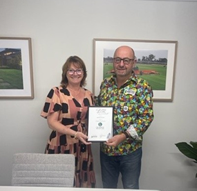 couple with framed certificate