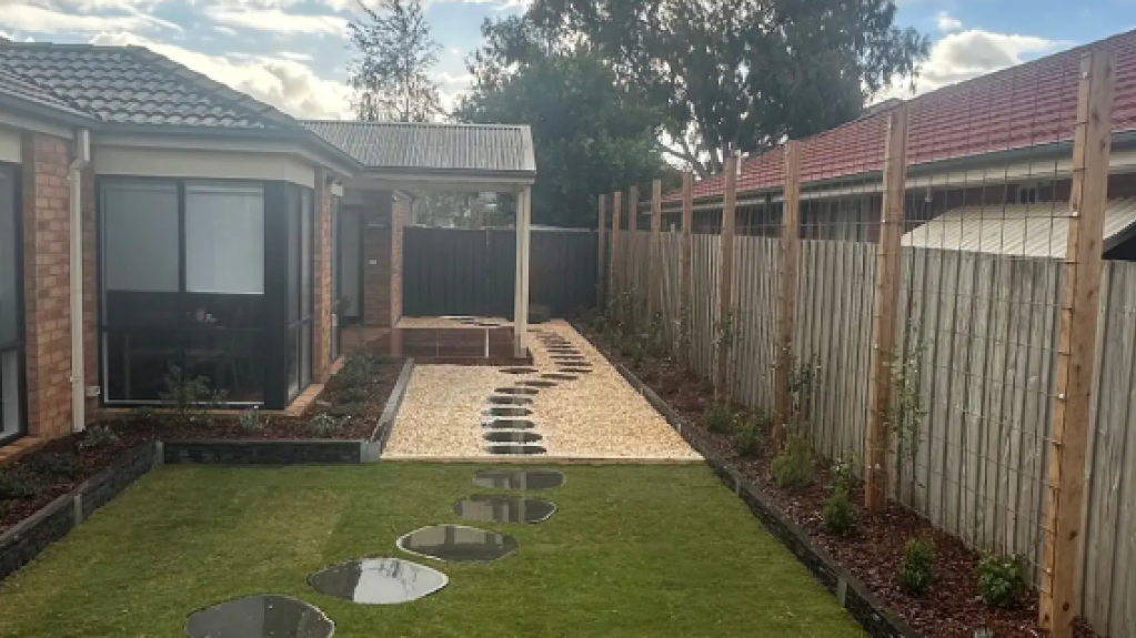 Newly landscaped Lynbrook backyard with freshly laid TifTuf Bermuda turf and clean garden edges.