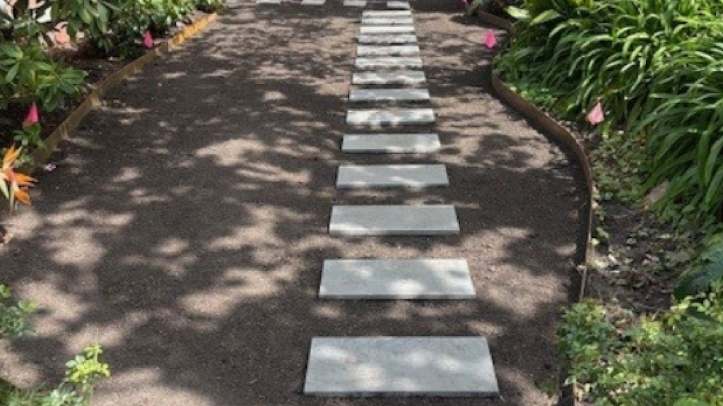 Front yard in Malvern prepared for Sir Walter DNA Certified Buffalo installation, with soil levelled and stepping stones positioned between curved garden beds.