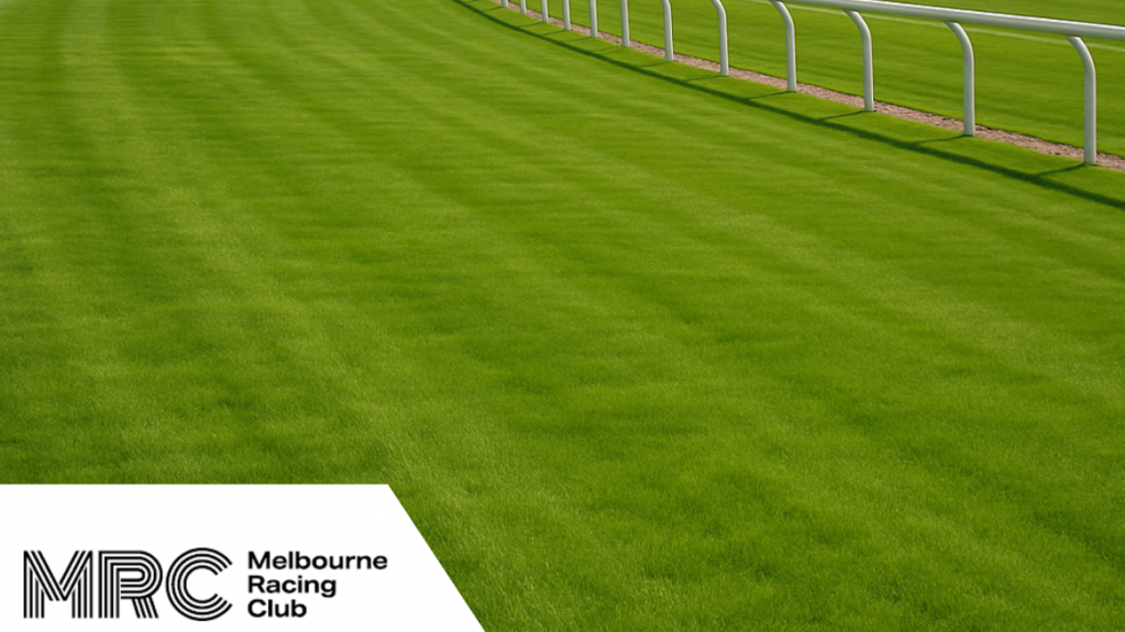 Manicured racetrack turf with a curved safety rail, featuring the Melbourne Racing Club logo in the corner.
