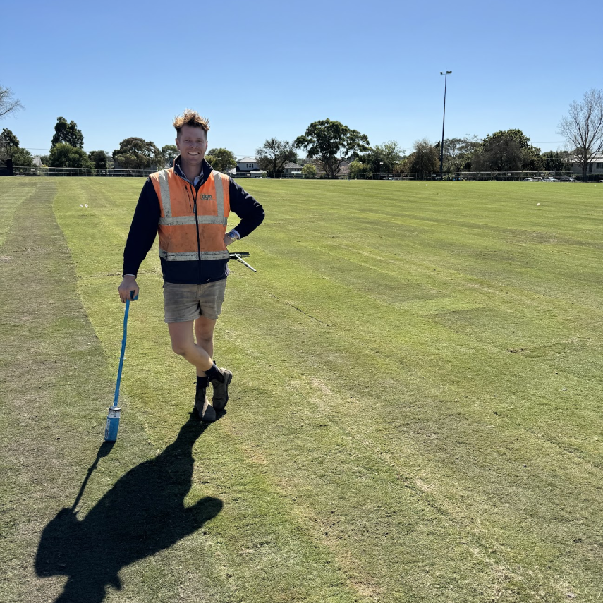 Worker standing on a newly turfed sports field