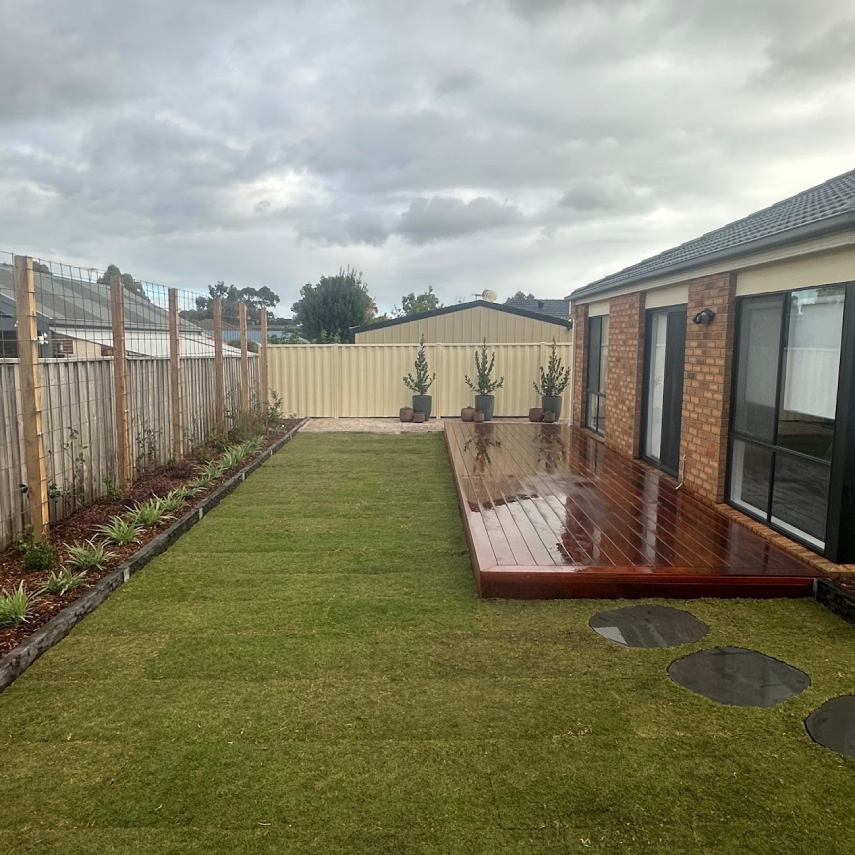 Finished backyard with fresh lawn, timber deck and garden beds