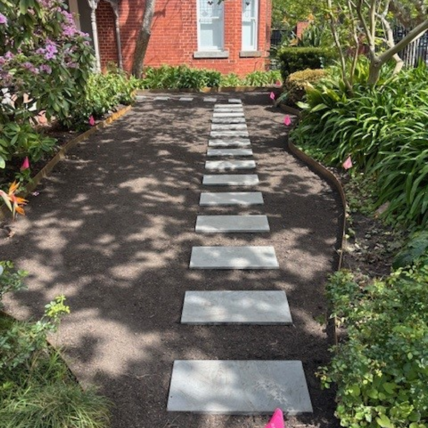 Stepping stone path through a freshly prepared front garden bed