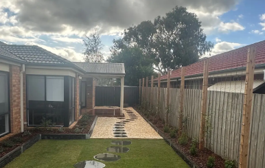 Newly landscaped Lynbrook backyard with freshly laid TifTuf Bermuda turf.